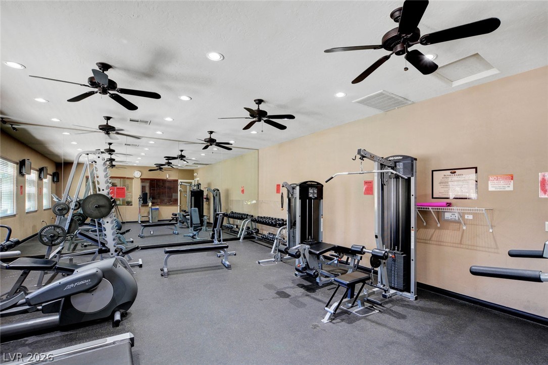 8985 South Durango Drive, Unit 2187 Las Vegas, NV 89113 - Photo 63 of 73 Fitness enthusiasts will appreciate this well-equipped workout space, featuring diverse exercise machinery.