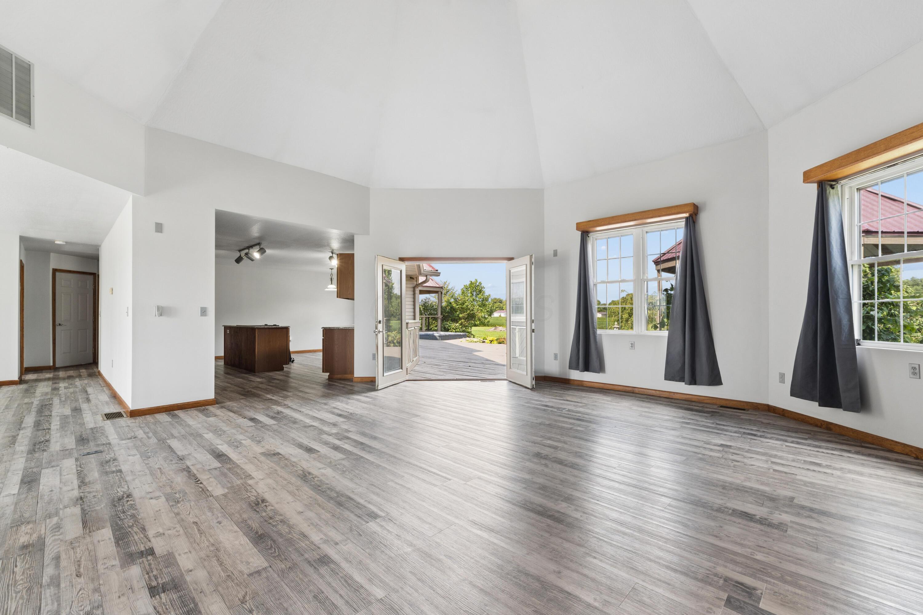 18964 London Road Circleville, OH 43113 - Photo 26 of 57 Vaulted ceilings, wood-finish flooring, multiple windows, French doors, and recessed lighting