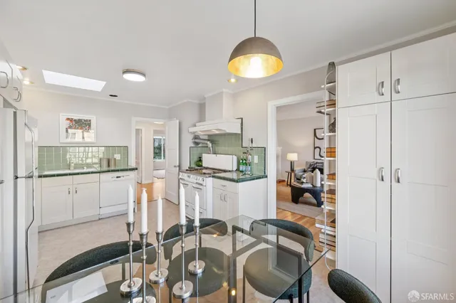 a kitchen with white cabinets a stove and a sink