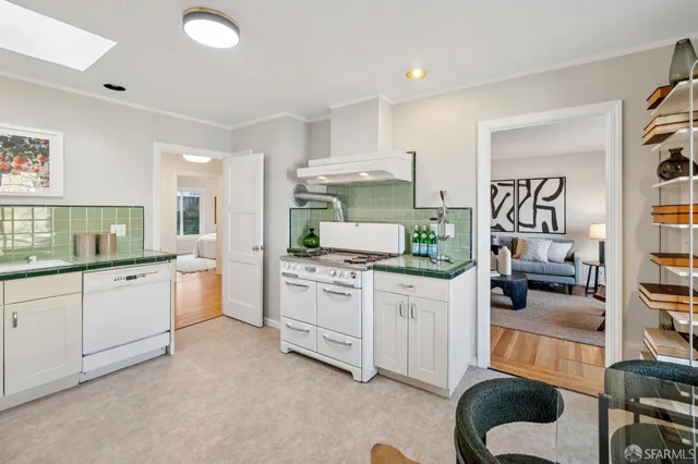 a stove top oven sitting inside of a kitchen
