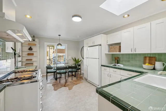 a view of a hallway with wooden floor and a bathroom