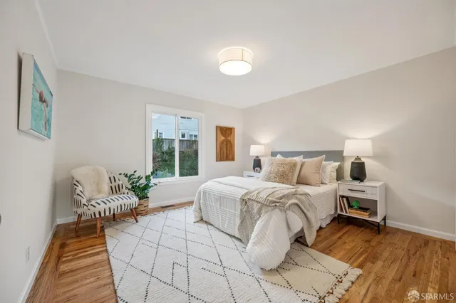 a bedroom with a large bed and a window