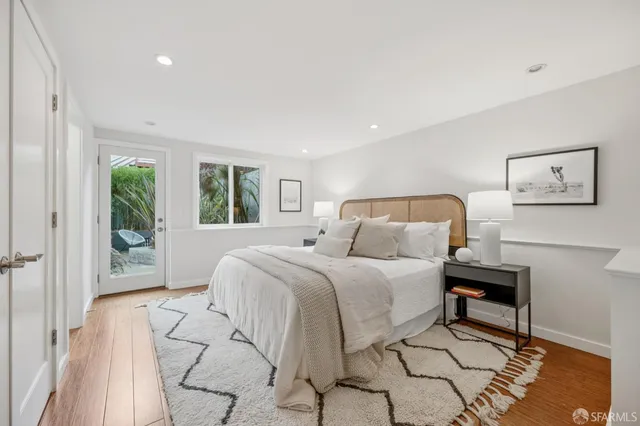 a bedroom with a large bed and a window