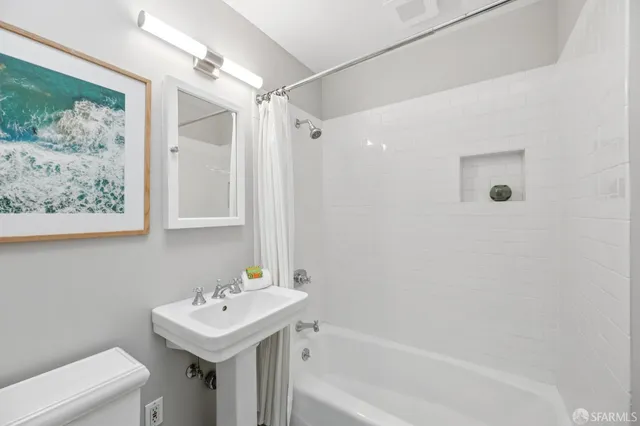 a bathroom with a shower and a sink