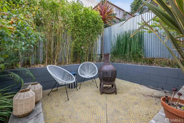 a view of a chairs and table in backyard