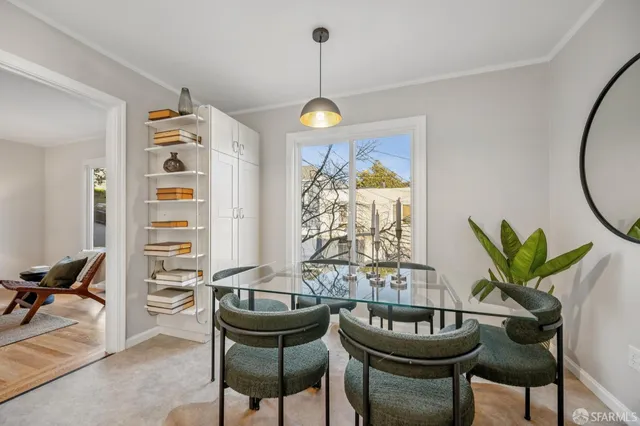 a view of a dining room with furniture and a potted plant
