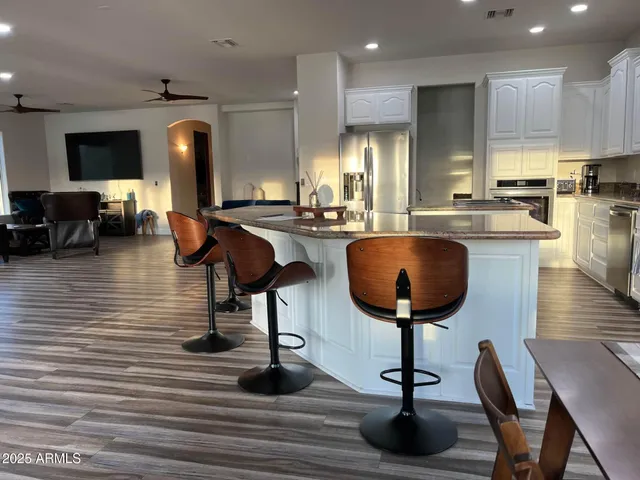 a view of a kitchen with kitchen island dining table and chairs