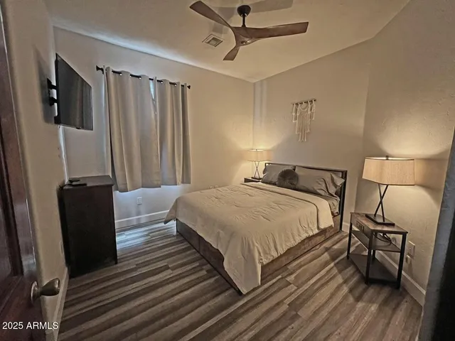 a bedroom with a bed and a mirror