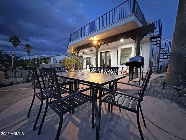 a view of a patio with table and chairs with wooden floor and plants