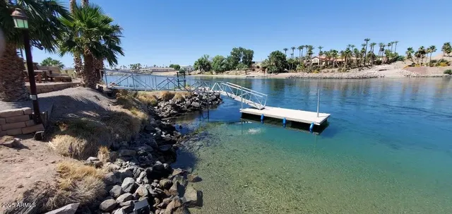 a view of a lake with a building and outdoor space