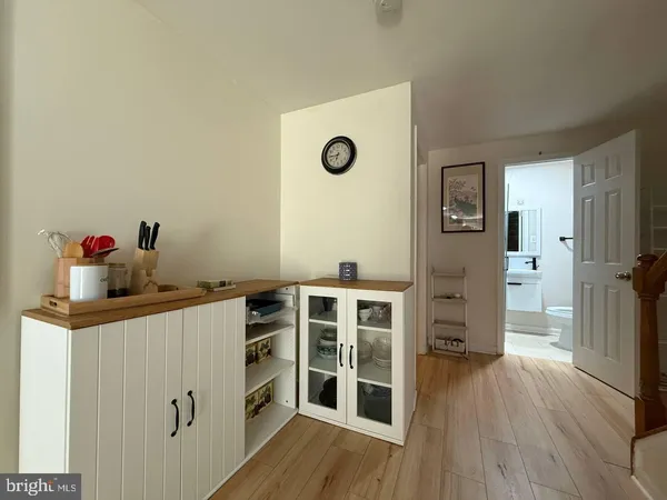 a view of a workspace with furniture and wooden floor