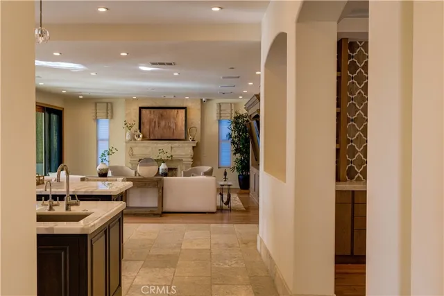 a bedroom with a bed a mirror on the dresser and floor