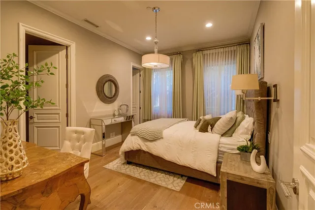 a spacious bedroom with a balcony a bed and wooden floor