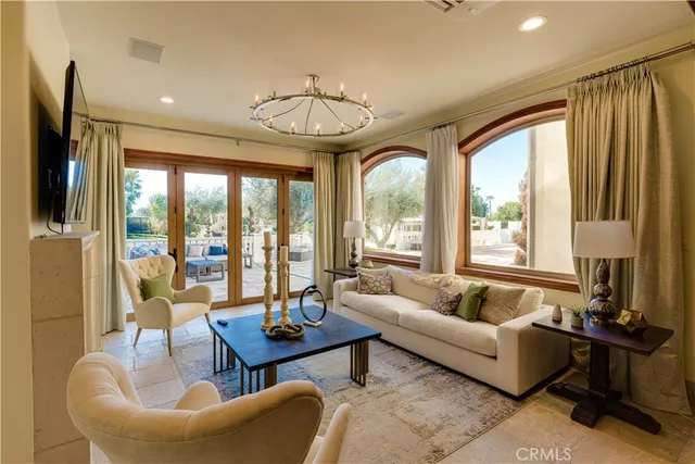 a living room with furniture and a mirror