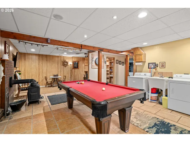 a living room with furniture a flat screen tv and a table