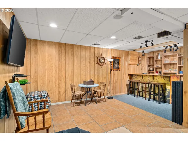 a dining room with stainless steel appliances kitchen island granite countertop furniture and a refrigerator