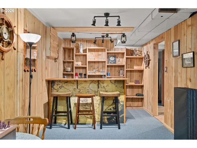 a dining room with furniture and a book shelf