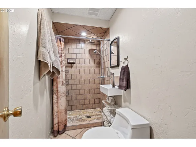a living room with furniture and a painting on the wall