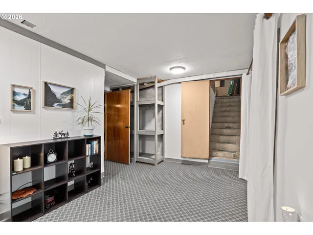 a backyard of a house with barbeque oven table and chairs