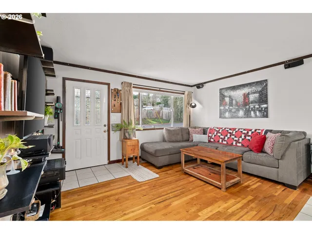 a living room with furniture a rug and gym equipment