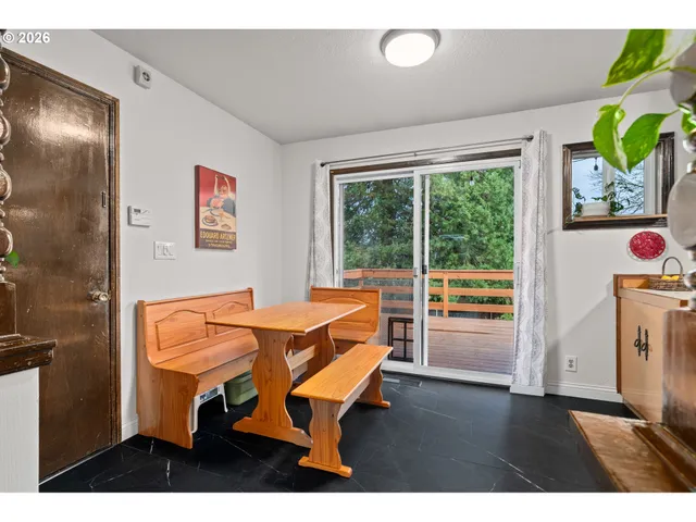 a living room with furniture and a kitchen view