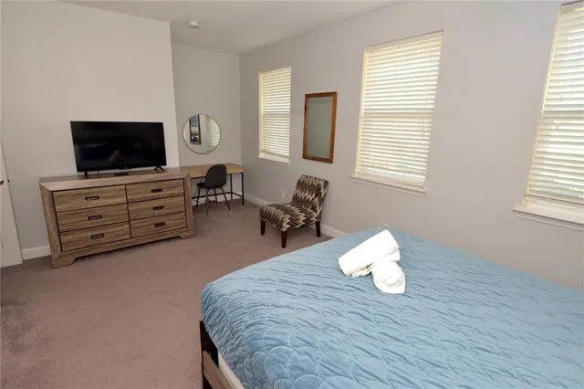 a bed room with furniture and flat screen tv