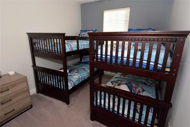 a view of a bedroom with wooden floor and a window
