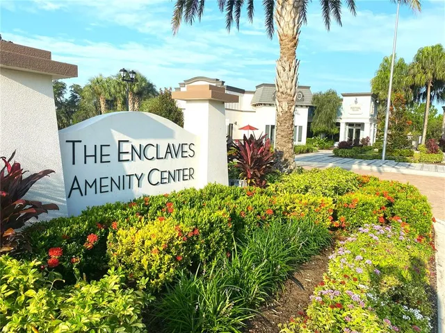 a view of sign board with buildings in the background