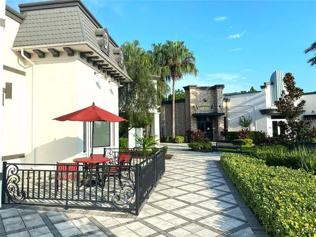 a view of a chairs and table under an umbrella