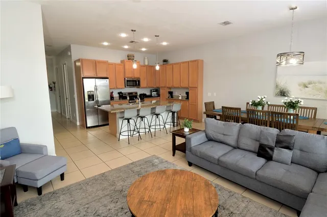 a living room with furniture kitchen view and a table