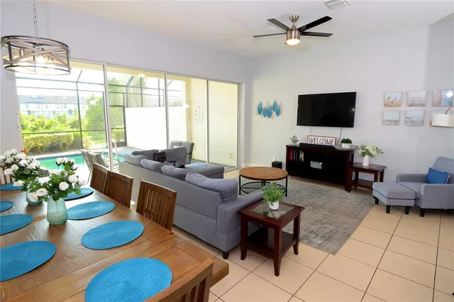 a living room with furniture a flat screen tv and a large window