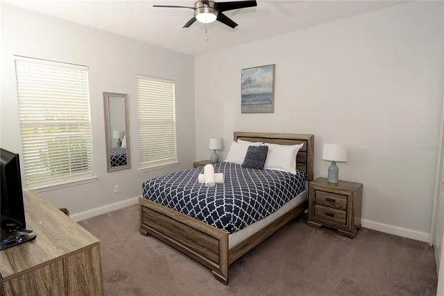 a bed sitting in a bedroom next to a window