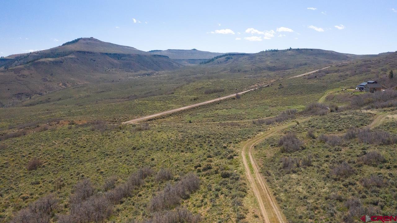 14111 County Road 26 Gunnison, CO 81230 - Photo 19 of 35 a view of a dry yard with mountains in the background