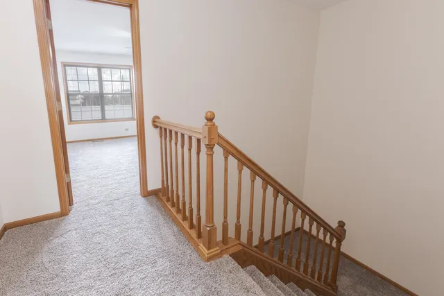 a view of a hallway with wooden floor and entryway