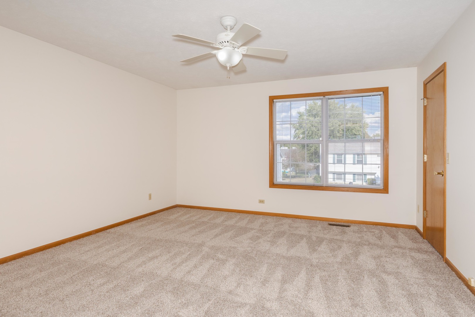 26 Vermont Avenue Bloomington, IL 61701 - Photo 16 of 37 an empty room with chandelier fan and windows