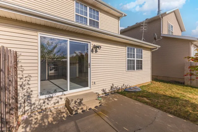 a view of backyard with wooden fence and flowers