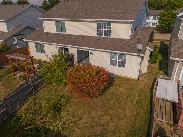 an aerial view of a residential apartment building with a yard