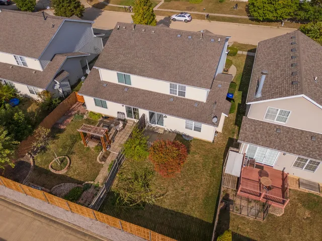 an aerial view of a house with garden space and ocean view