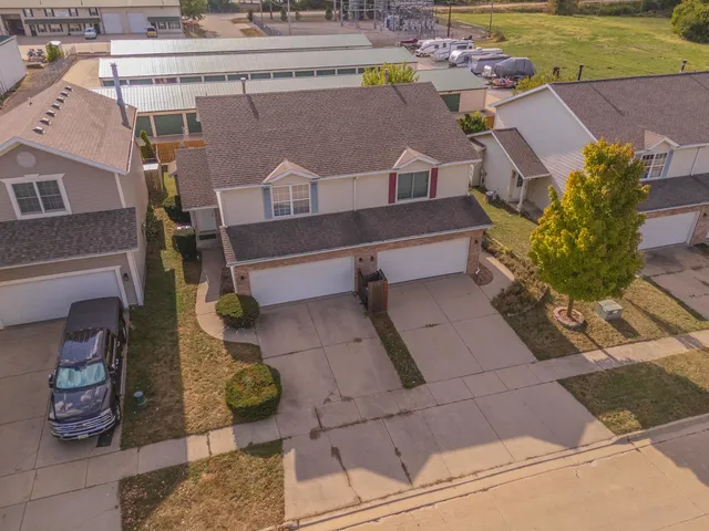 an aerial view of a house with a yard