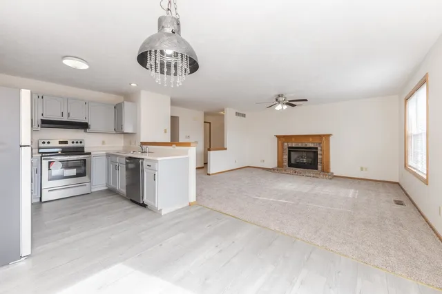 a kitchen with stainless steel appliances granite countertop a stove oven and a refrigerator