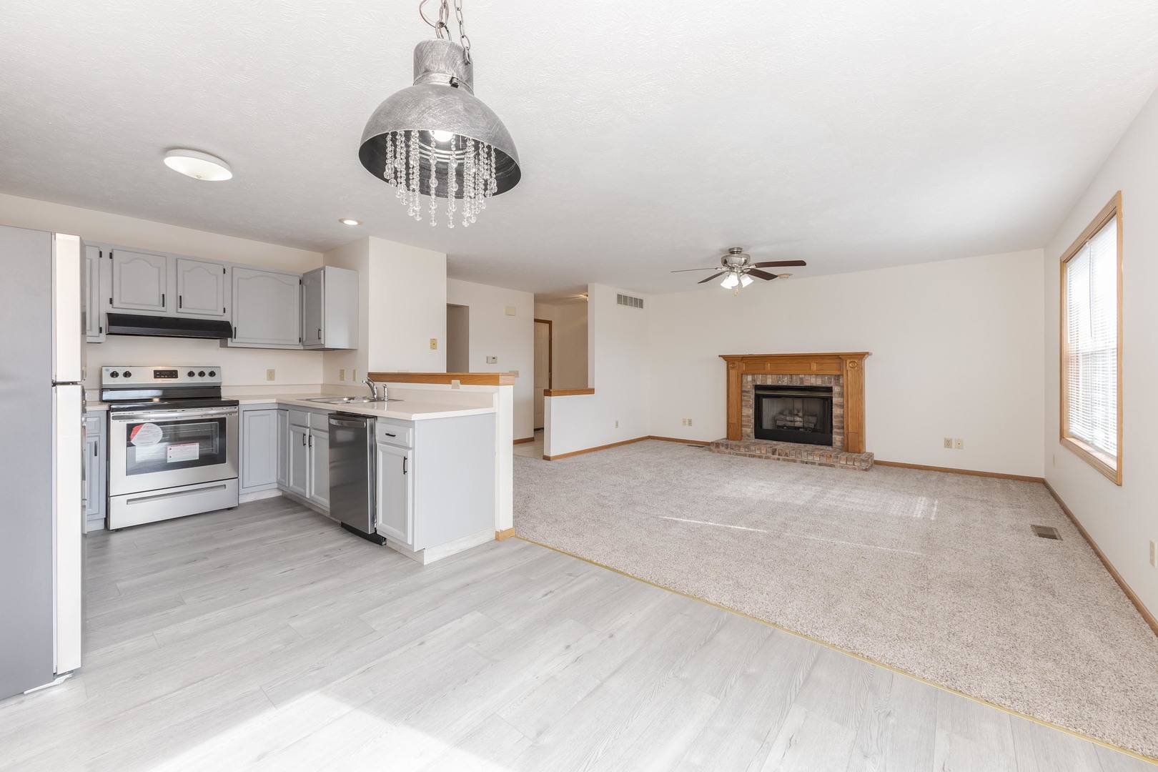 26 Vermont Avenue Bloomington, IL 61701 - Photo 7 of 37 a kitchen with stainless steel appliances granite countertop a stove oven and a refrigerator
