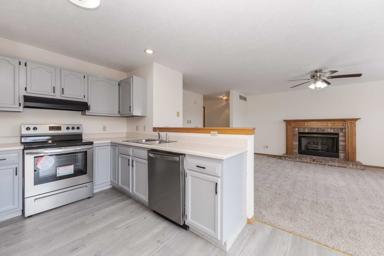 26 Vermont Avenue Bloomington, IL 61701 - Photo 8 of 37 a kitchen with granite countertop a stove top oven and cabinets