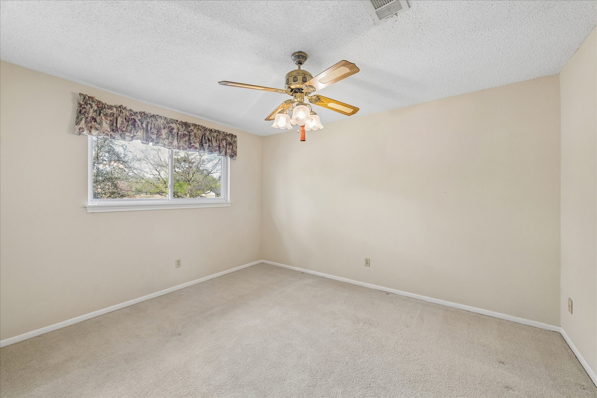 322 Enchanted River Drive Spring, TX 77388 - Photo 20 of 28 an empty room with a window and a fan