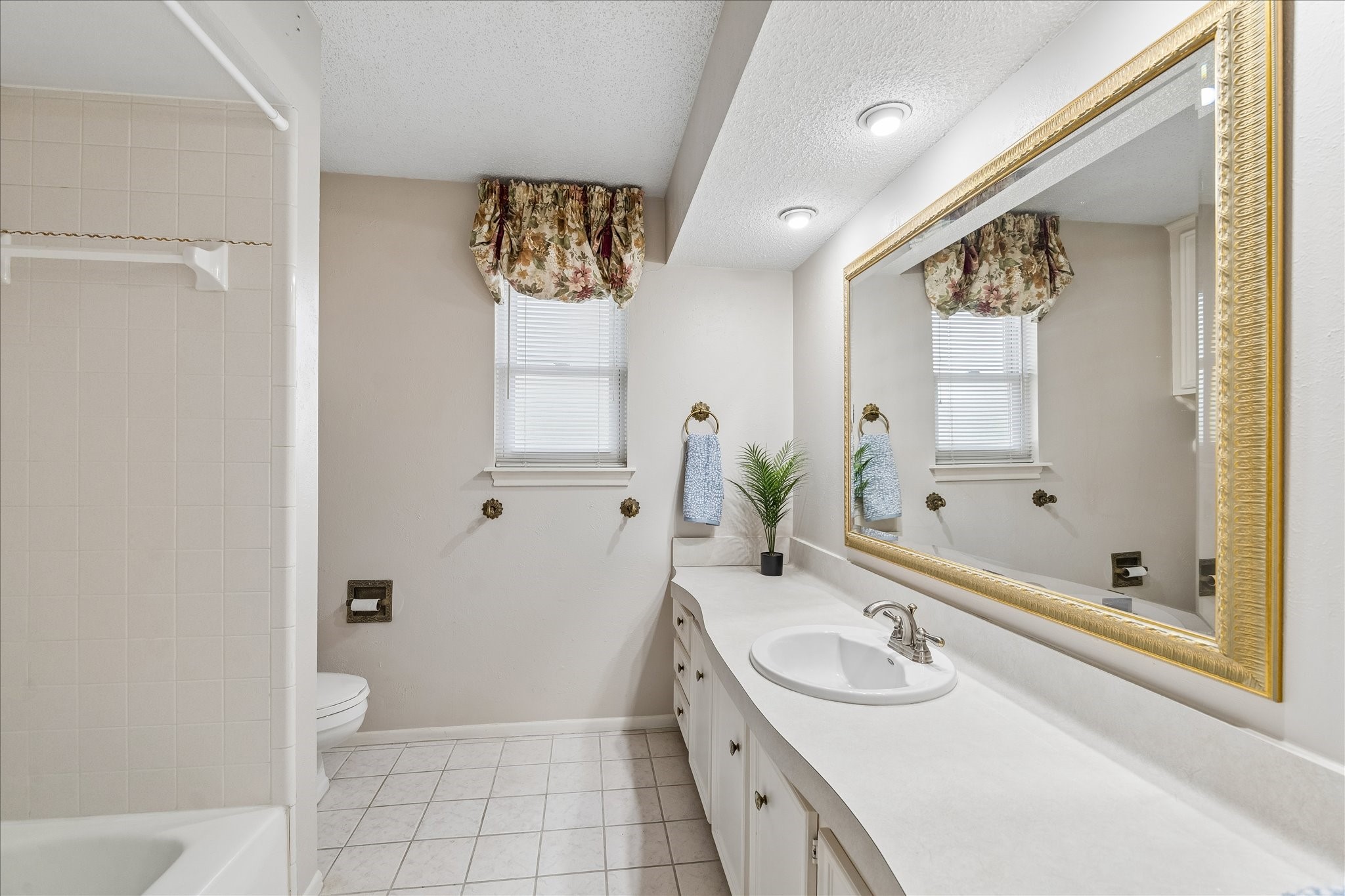 322 Enchanted River Drive Spring, TX 77388 - Photo 21 of 28 a spacious bathroom with a granite countertop sink a toilet and shower