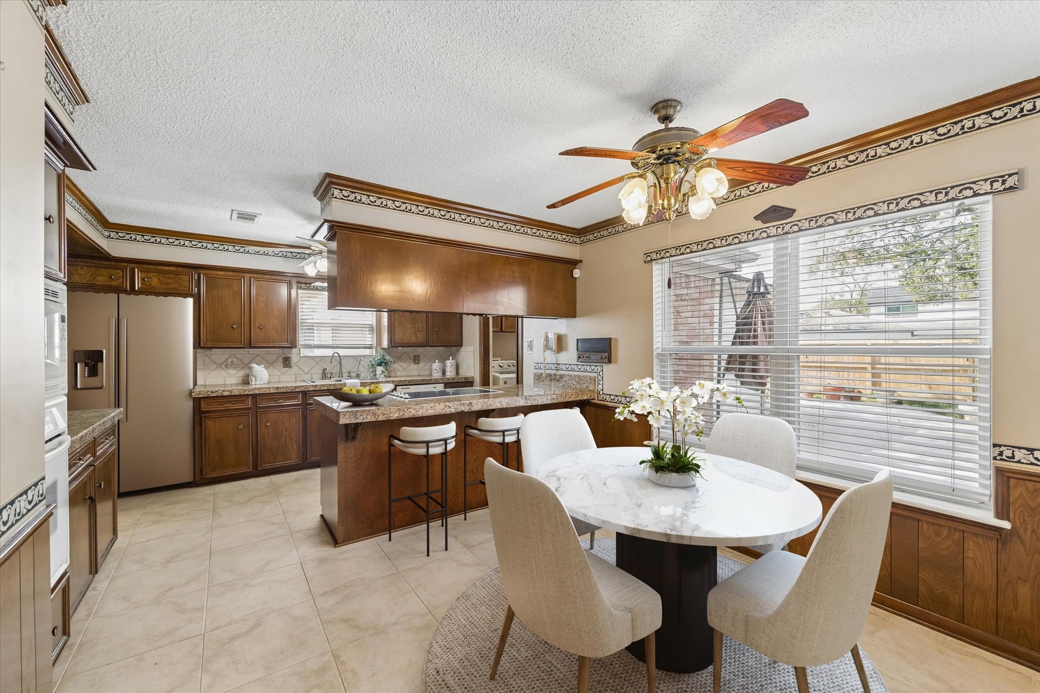 322 Enchanted River Drive Spring, TX 77388 - Photo 7 of 28 a kitchen with a dining table chairs stainless steel appliances and cabinets