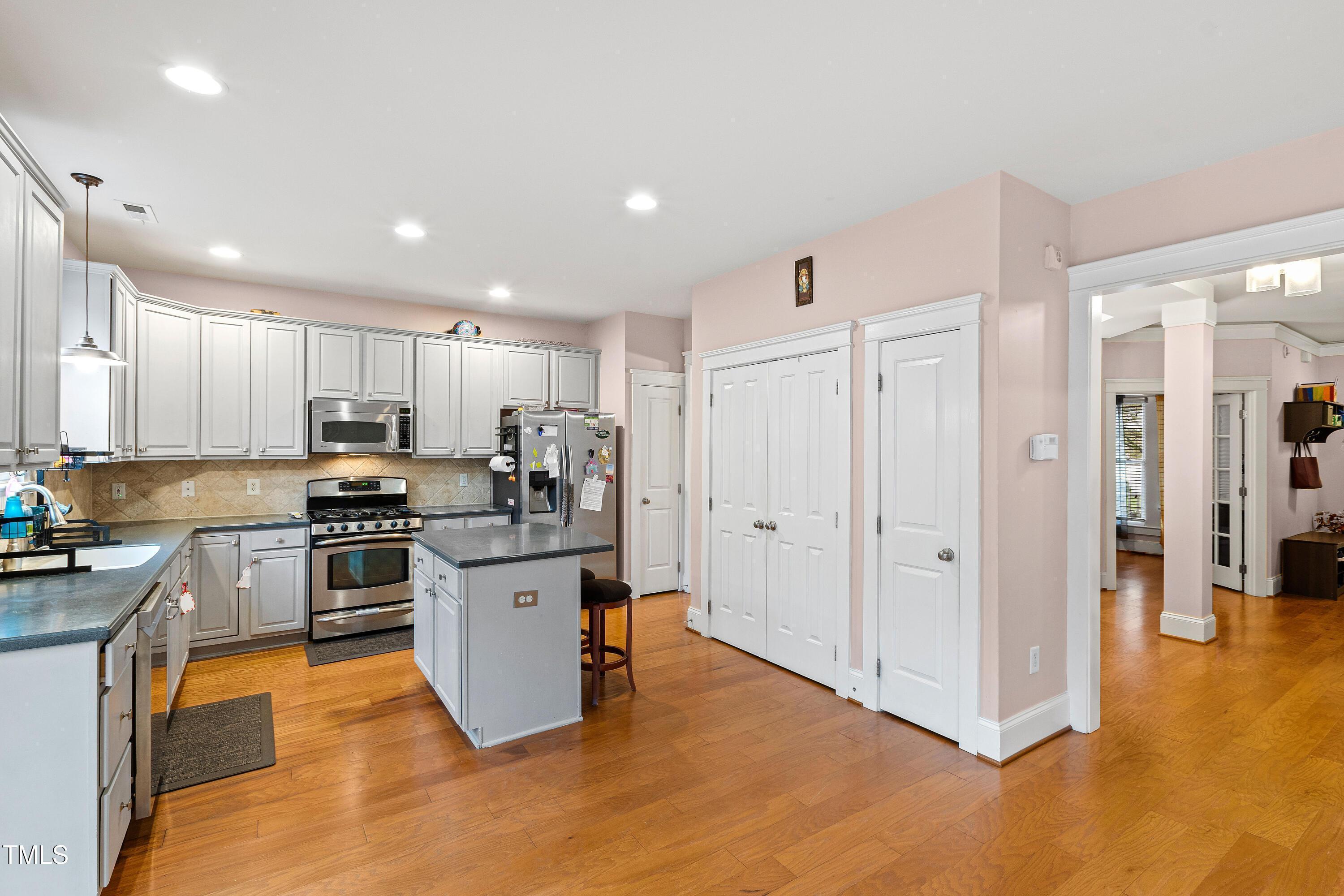 204 Frontgate Drive Cary, NC 27519 - Photo 11 of 41 a kitchen with stainless steel appliances granite countertop a refrigerator and a stove top oven