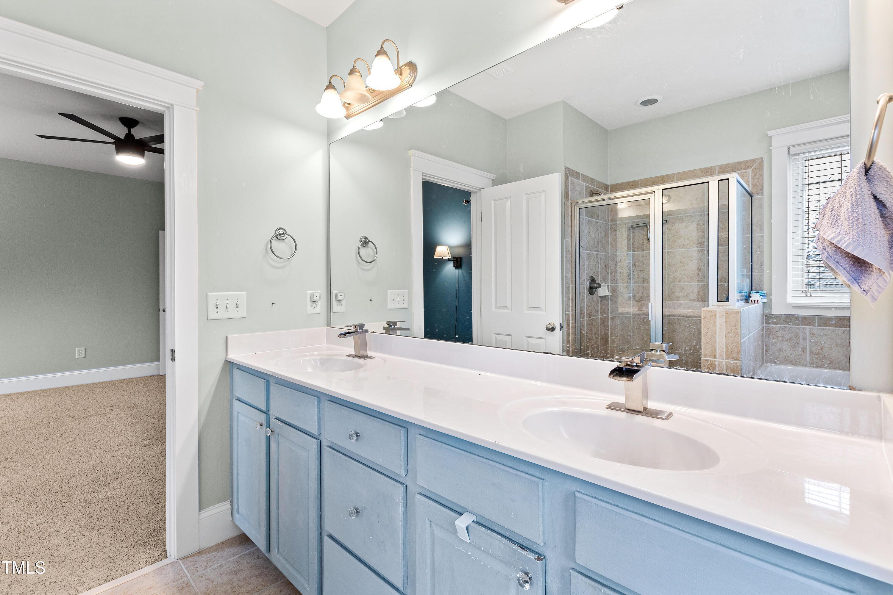 204 Frontgate Drive Cary, NC 27519 - Photo 34 of 41 a bathroom with a sink double vanity and a mirror
