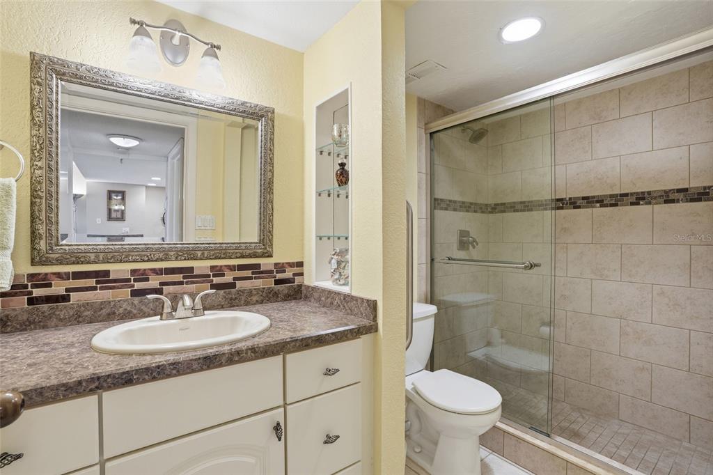 3170 Matecumbe Key Road, Unit 127 Punta Gorda, FL 33955 - Photo 13 of 22 a bathroom with a granite countertop sink toilet and a mirror