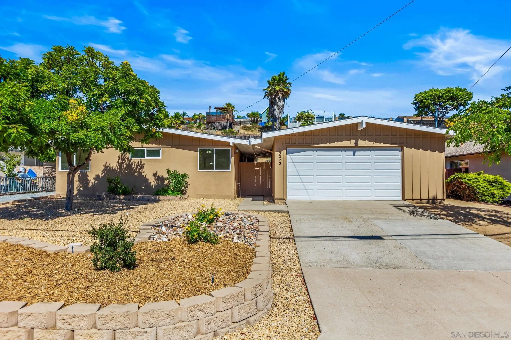 a front view of a house with a yard and a garage