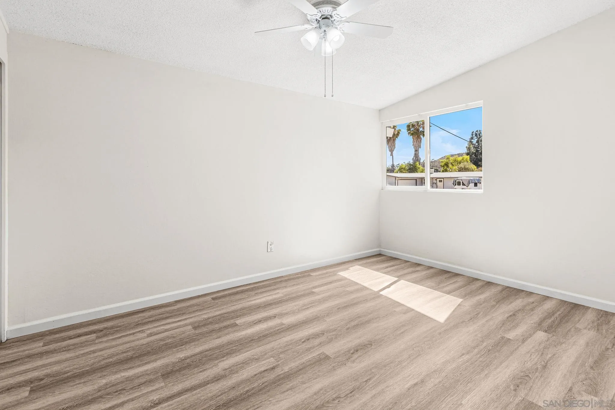 13323 Frame Road Poway, CA 92064 - Photo 14 of 30 an empty room with a window and a fan